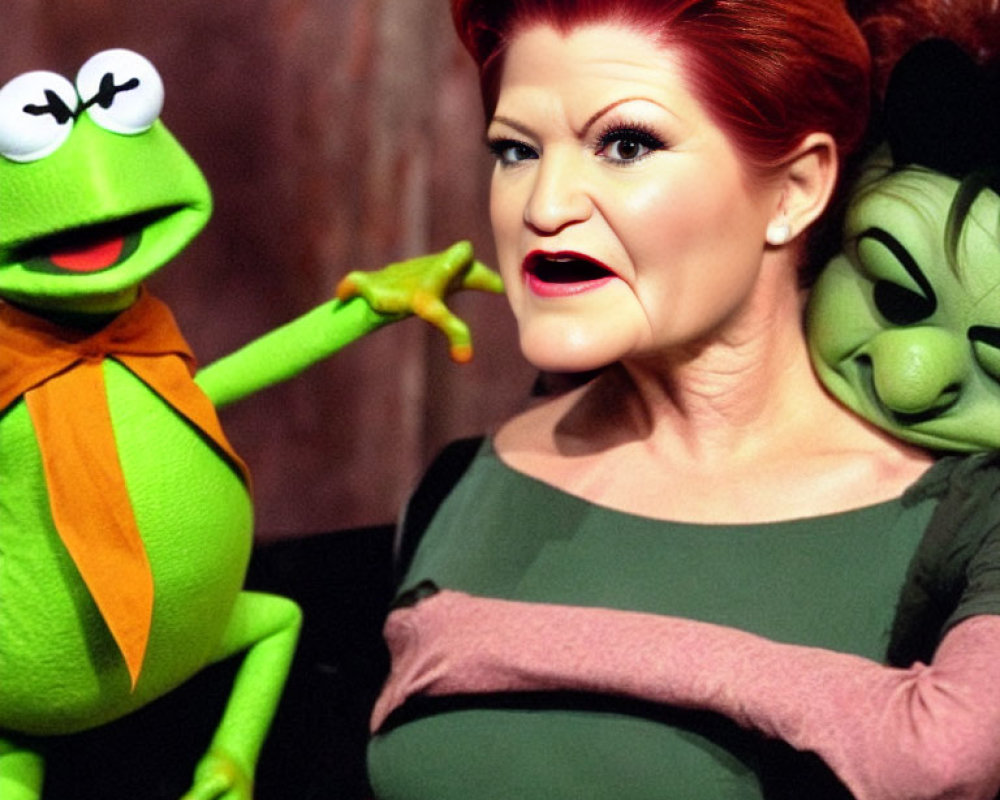 Woman with green amphibian and character puppets in collar.