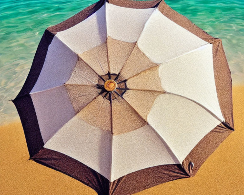 Vibrant umbrella on sandy beach with turquoise water