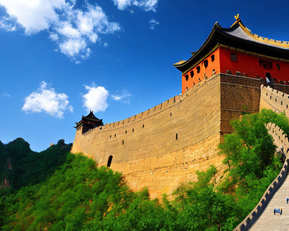 Great Wall of China section with watchtower winding through green hills under clear blue sky