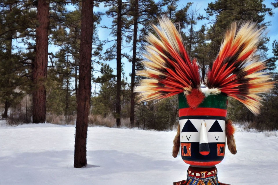 Vibrant tribal mask with feather headdress in snowy forest landscape