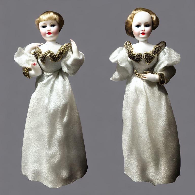 Vintage porcelain dolls with pale complexions in golden and white dresses on grey background