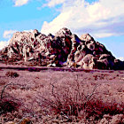 Desert landscape with red rock formations under blue sky