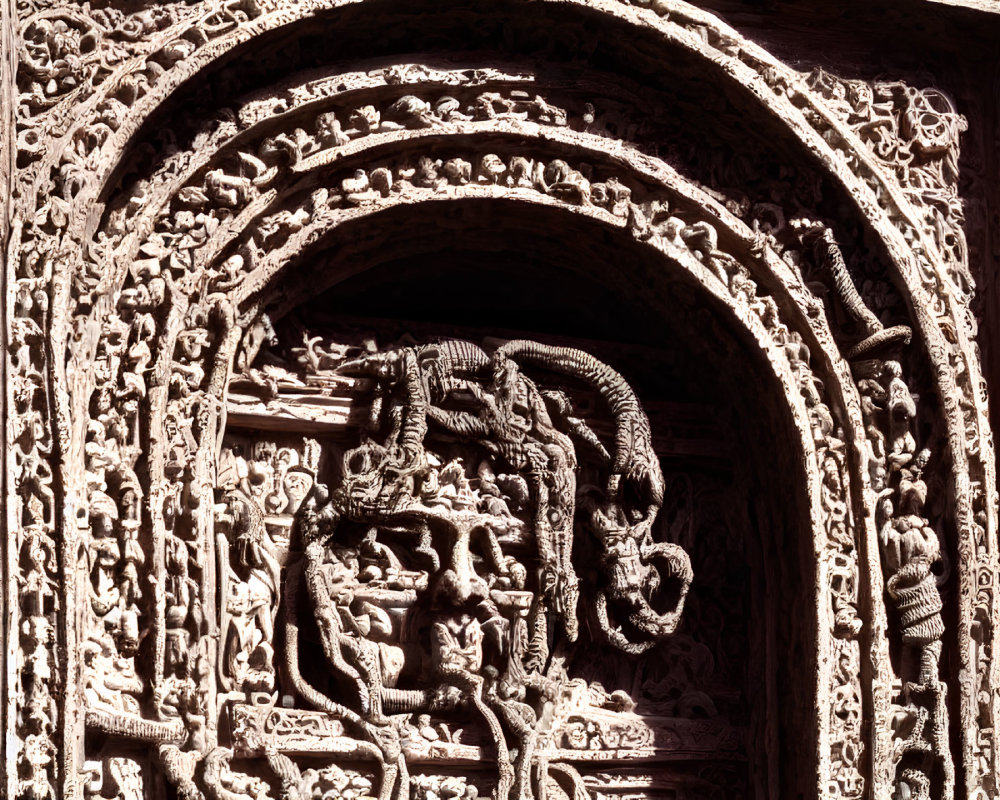 Intricate Hindu deity stone carving in temple arch