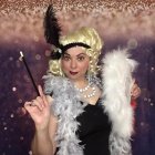 Portrait of Woman in 1920s Flapper Style with Headband and Feather Boa