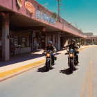 Two motorcyclists in front of vintage building under clear blue sky
