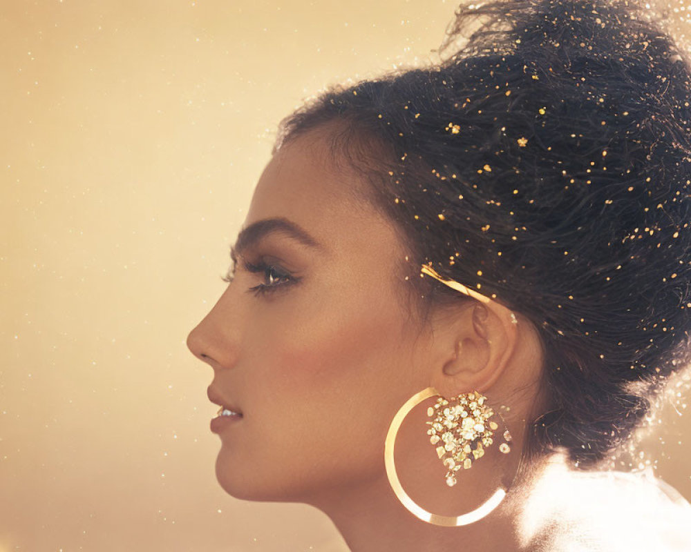 Woman Profile with Glitter Hair & Elegant Earrings on Golden Background