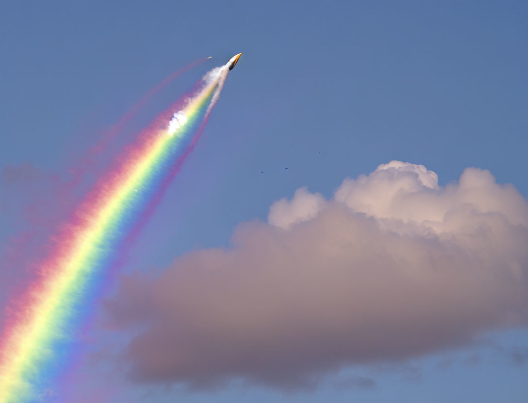 Colorful Spectrum Trail Rocket in Blue Sky
