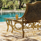 Luxurious Golden Bench with Blue Upholstery by Tranquil Pool and Columned Pavilion