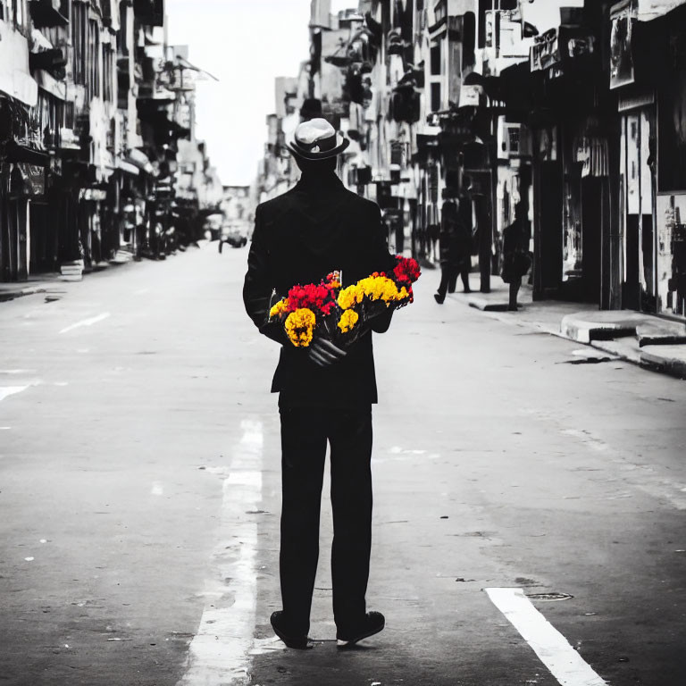 Person in Dark Suit Holding Bouquet on Deserted Street
