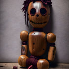 Wooden Figure with Button Eyes and Stitched Mouth on Metal Chain Against Wooden Backdrop