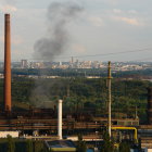 Industrial landscape with smokestacks, structures, and greenery