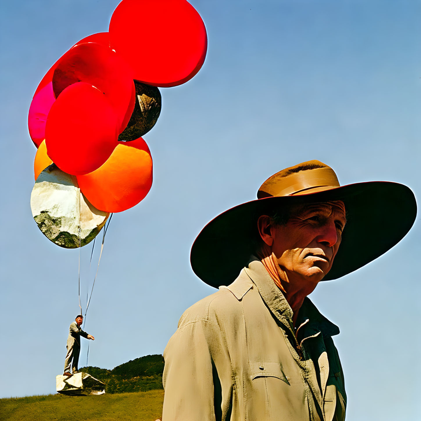 Two men in beige jacket and hat against blue sky, one pensive, other holding colorful balloons.