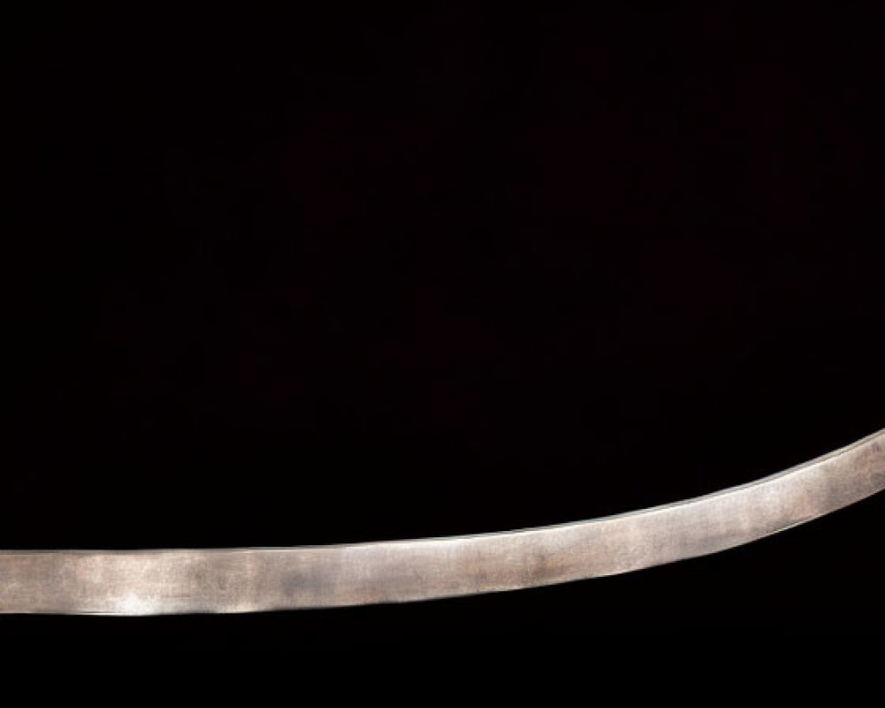 Curved sword with sharp edge and hilt on dark background