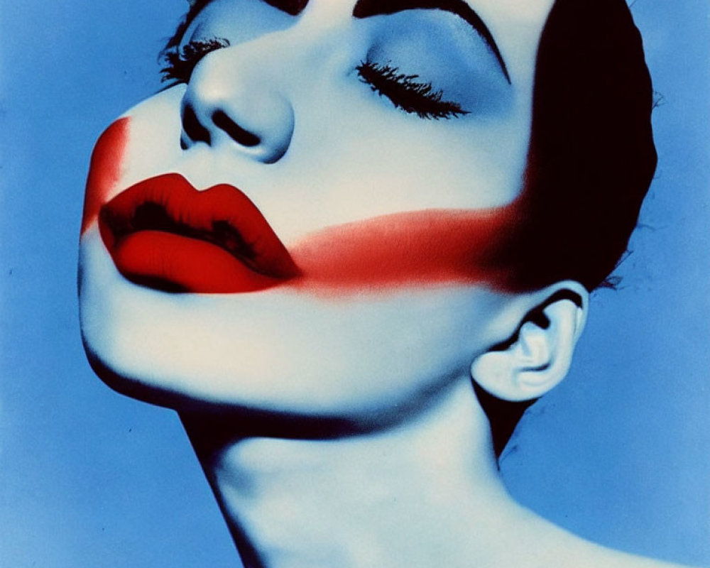 Woman's face with bold red lipstick and red stripe on blue background