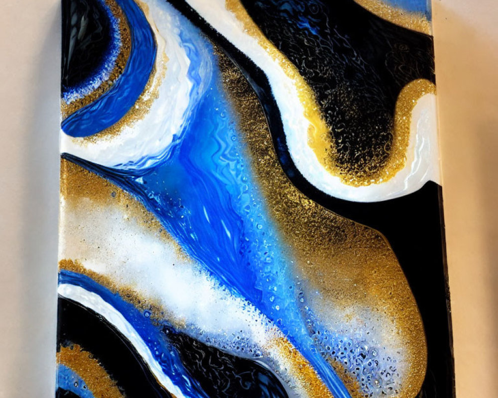 Swirling blue, black, and gold fluid art on square canvas