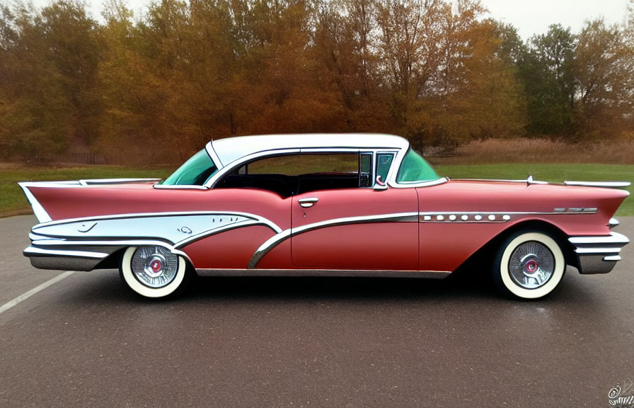 Vintage Red and White Car with Tail Fins and Chrome Accents on Empty Road