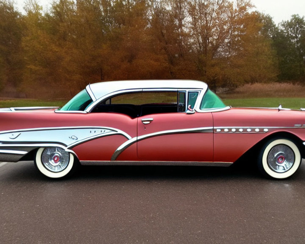 Vintage Red and White Car with Tail Fins and Chrome Accents on Empty Road