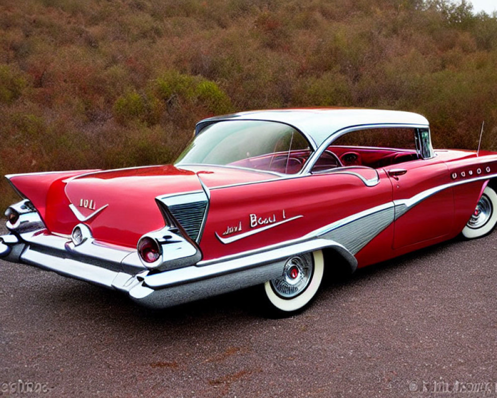 Vintage Red and White Two-Toned Car with Tailfins and White-Wall Tires on Asphalt