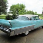 Vintage Turquoise and White Cadillac with Tail Fins on Sandy Path