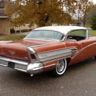 Vintage Red and White Two-Toned Car with Tailfins and White-Wall Tires on Asphalt