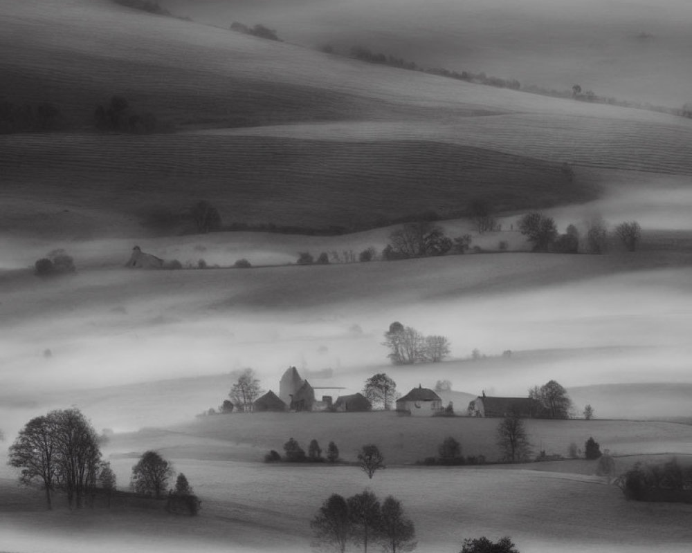 Serene monochrome landscape with mist, hills, trees, and buildings