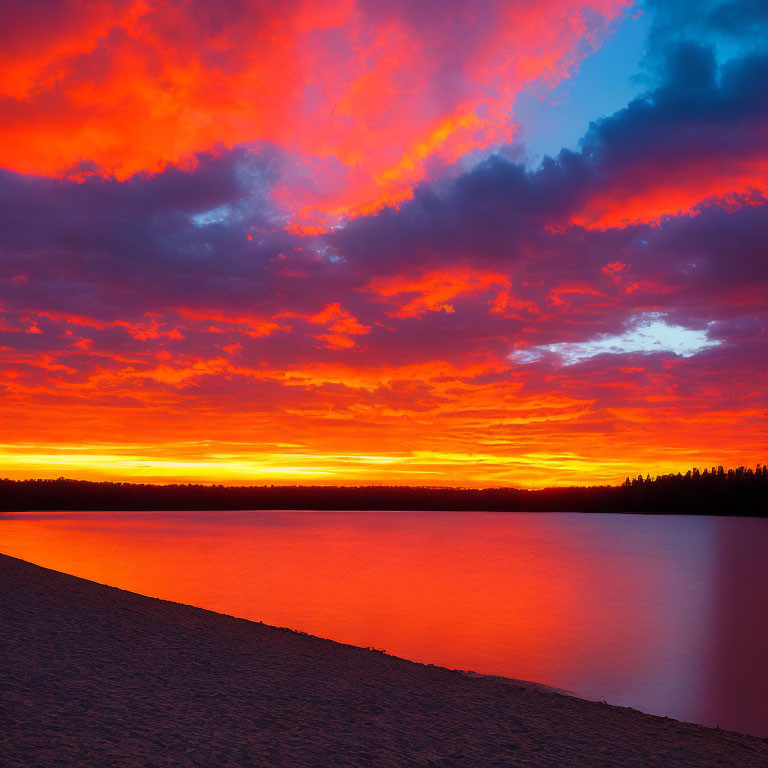 Fiery orange and red sunset reflected on calm lake