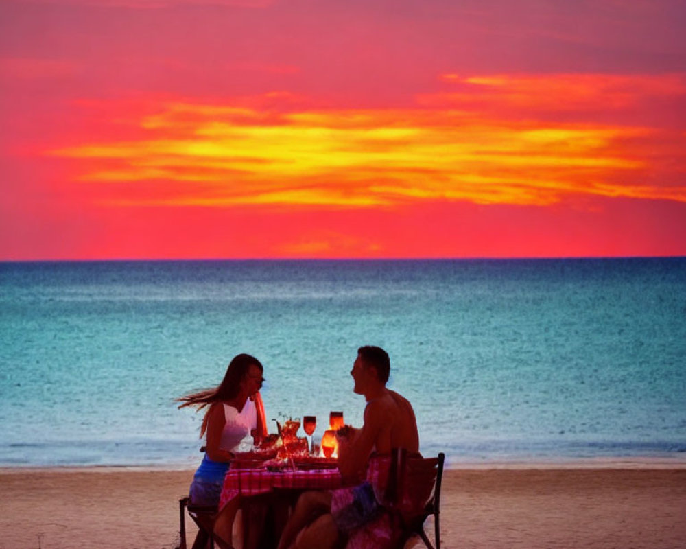 Romantic beach sunset dinner with vivid orange skies