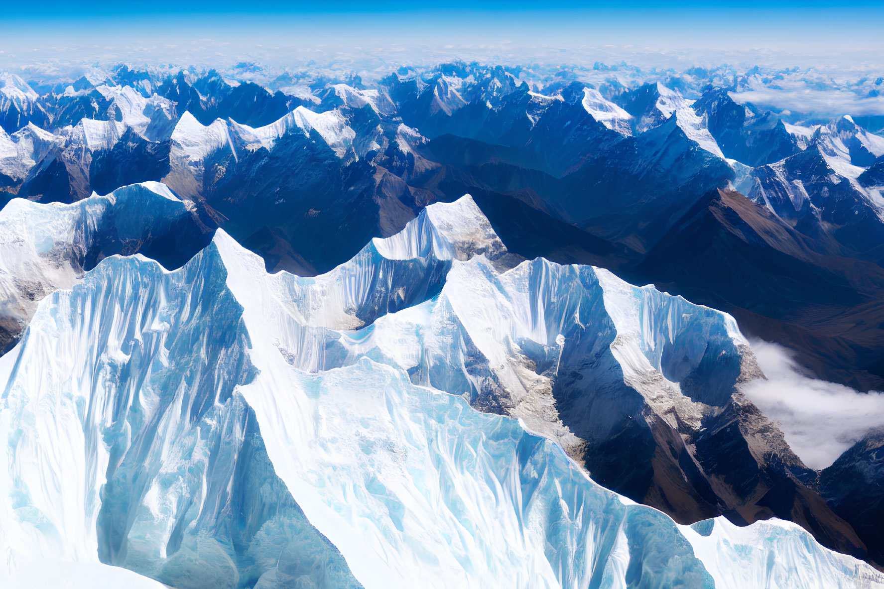 Snow-capped mountain range with glaciers in aerial view