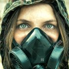 Intense-eyed woman in gas mask with German flag and brown hair