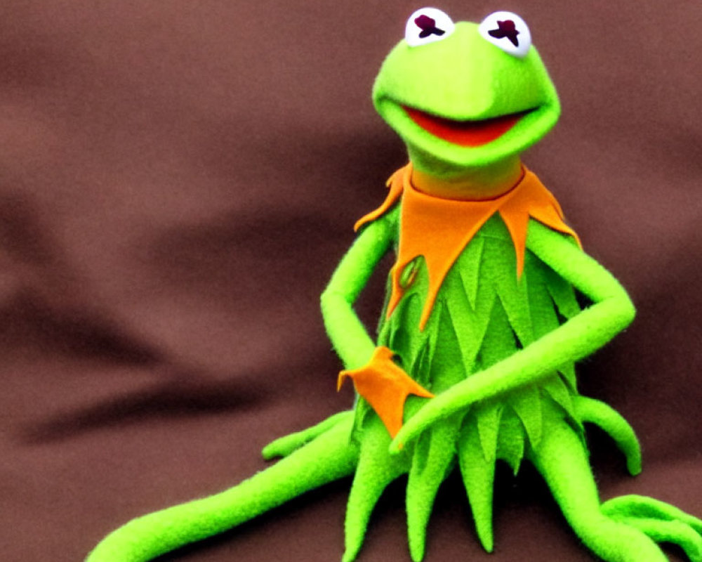 Bright Green Kermit the Frog Plush Toy on Brown Background