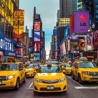 Colorful city street scene with yellow taxis under twilight sky