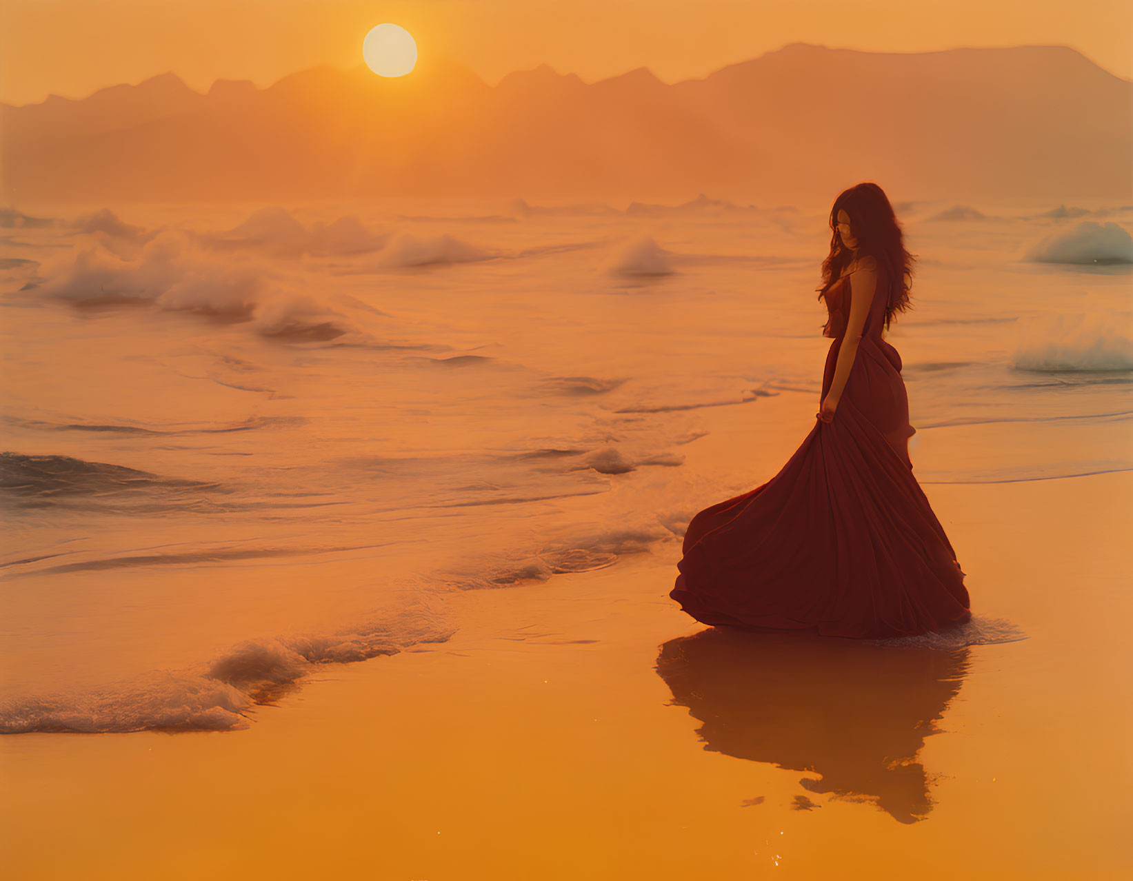 Silhouette of woman in flowing dress on beach at sunset