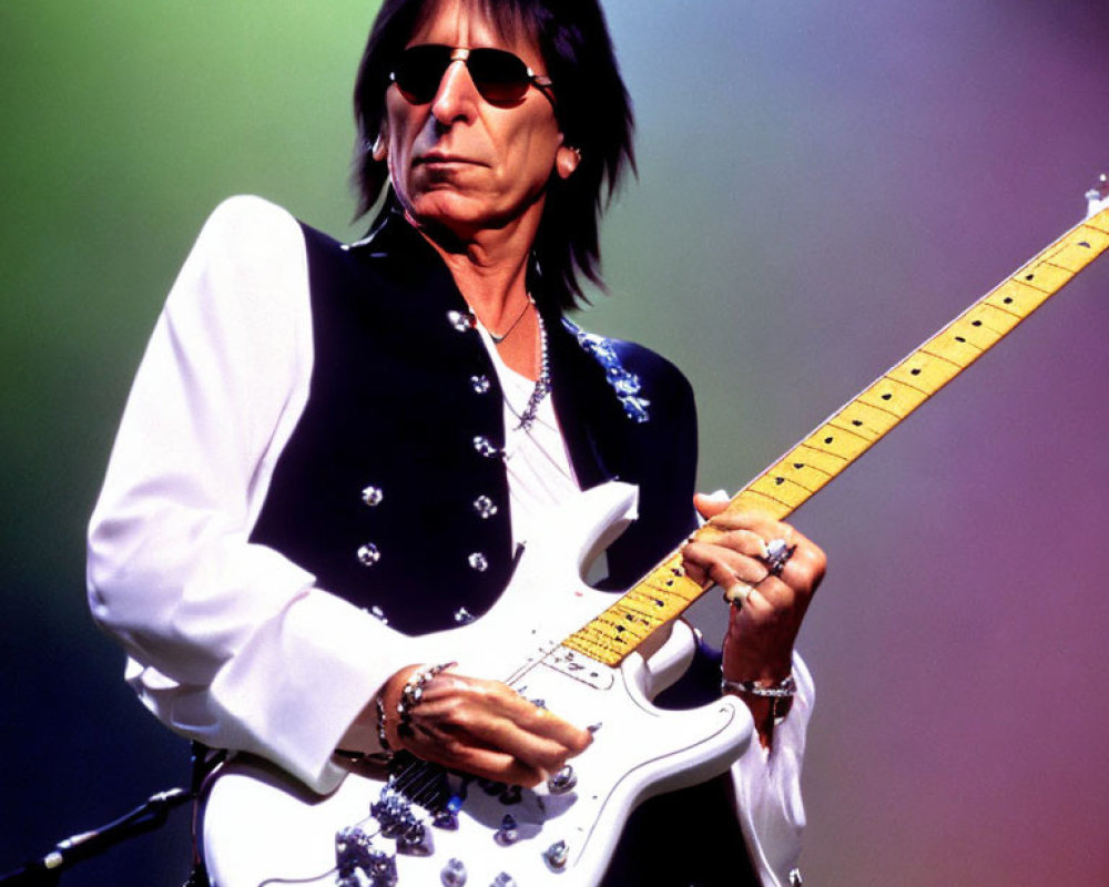 Musician with Long Dark Hair Plays White Electric Guitar on Stage