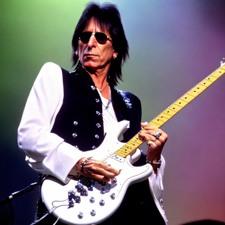Musician with Long Dark Hair Plays White Electric Guitar on Stage