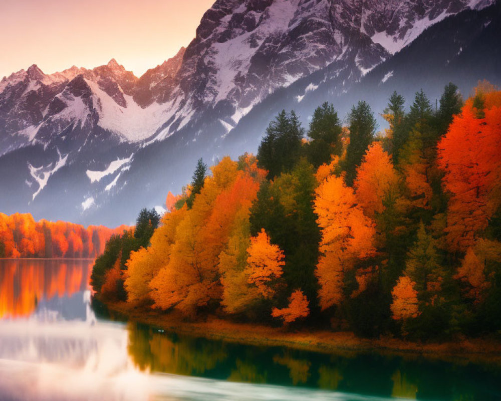 Vibrant orange autumn trees by tranquil lake with snow-capped mountains at dusk