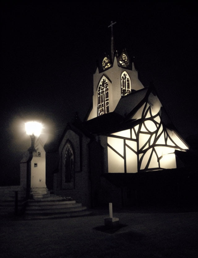 Dimly Lit Church at Night with Glowing Cross and Stained-Glass Windows