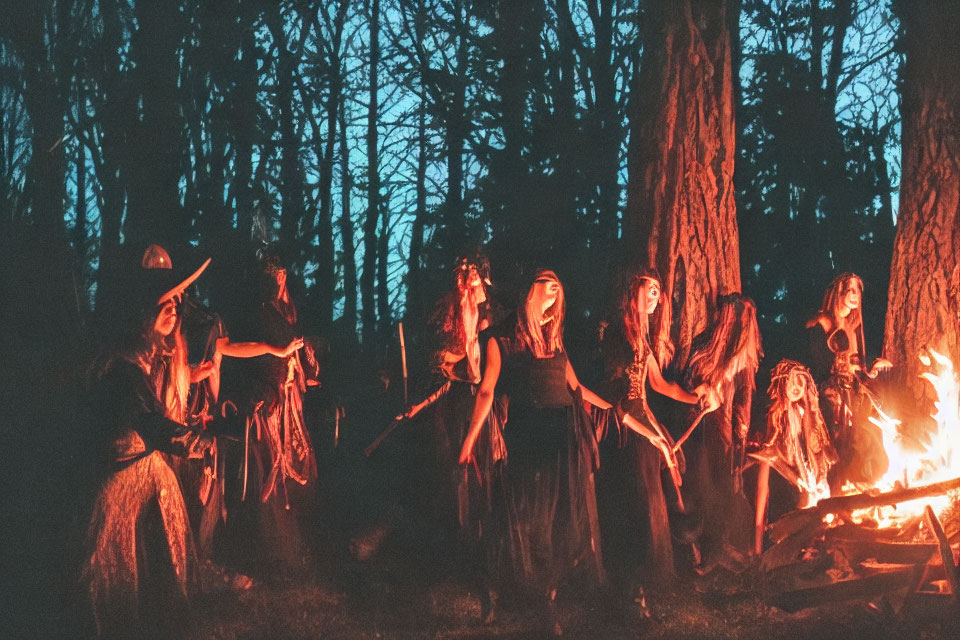 Group of People in Costumes Around Nighttime Forest Bonfire