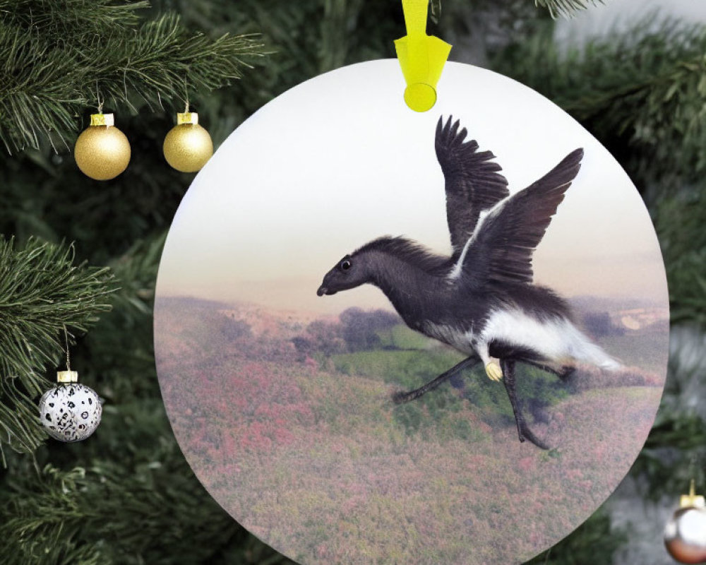 Circular Christmas ornament with flying goose and gold baubles