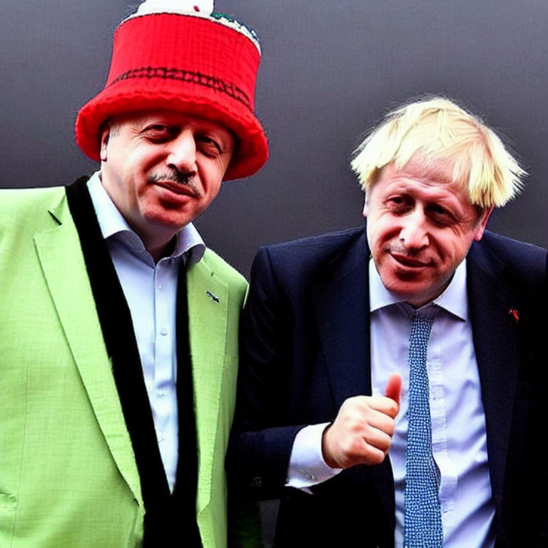 Men in bright green suit and red hat with disheveled blond man giving thumbs-up