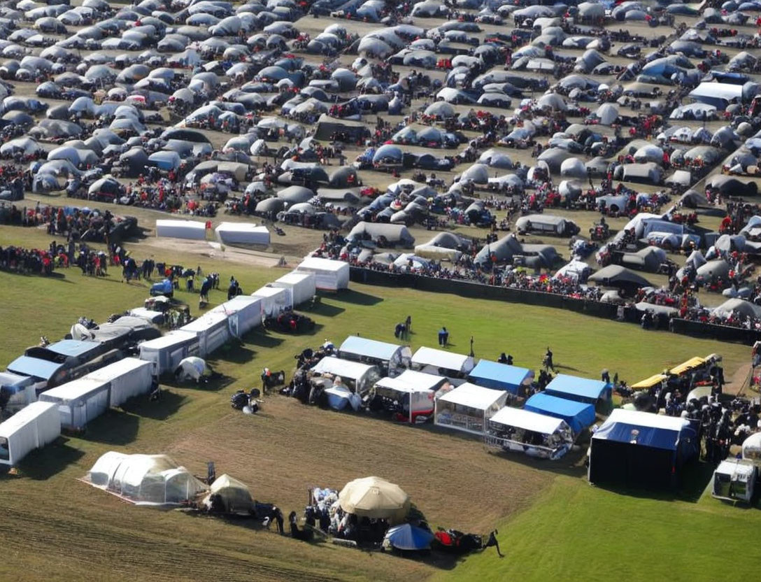 Outdoor Event: Tents, Stalls, and Crowded Parking with Cars